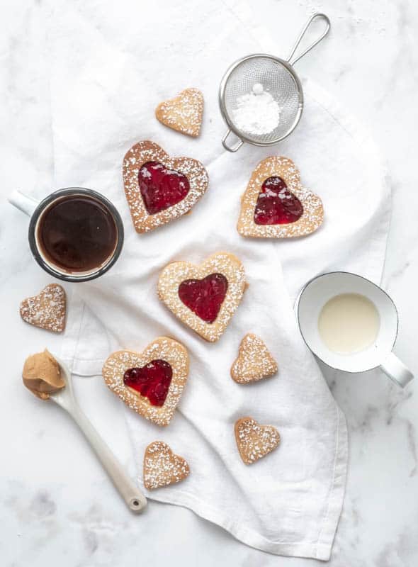 Heart Cookies with Homemade Spiced Cherry Jam shown next to milk and coffee