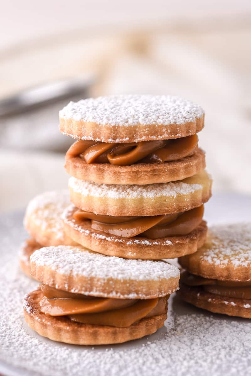 Dulce de Leche Cookies shown on a plate dusted in icing sugar.