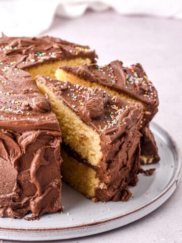 Image shows whole cake on a plate, some slices have been cut.