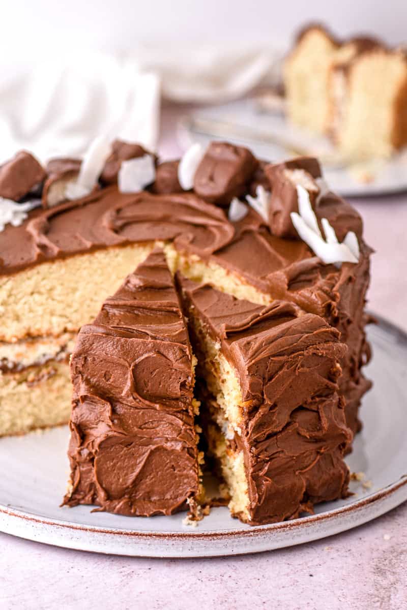 Image showing the cake with a few slices cut, there is one slice missing so you can see the layers inside the cake. 